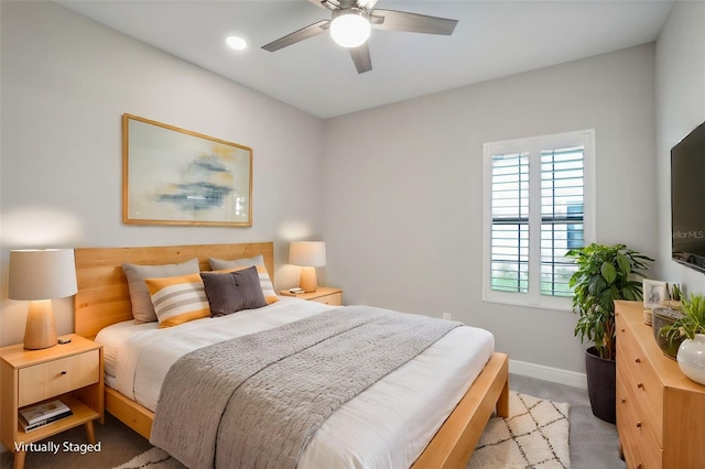 bedroom featuring light carpet and ceiling fan