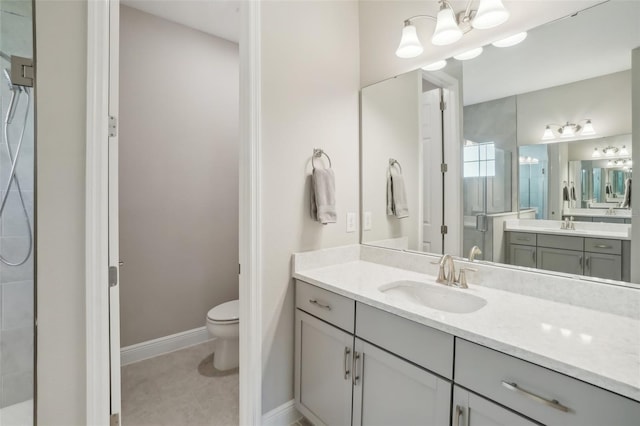 bathroom featuring a shower, vanity, and toilet