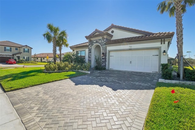 mediterranean / spanish house with a garage and a front yard