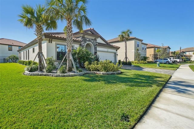 view of front facade featuring a front yard and a garage