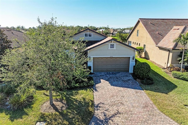 view of front of property with a garage and a front yard