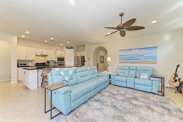 tiled living room featuring ceiling fan