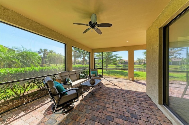 unfurnished sunroom with ceiling fan