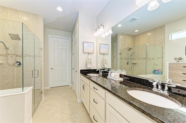 bathroom with vanity, tile patterned floors, and walk in shower