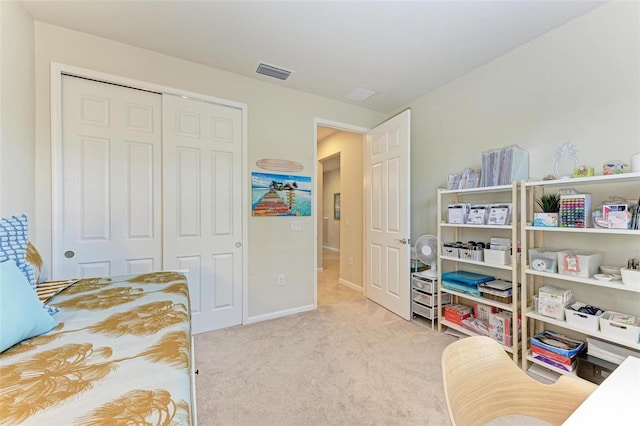 bedroom with light carpet and a closet