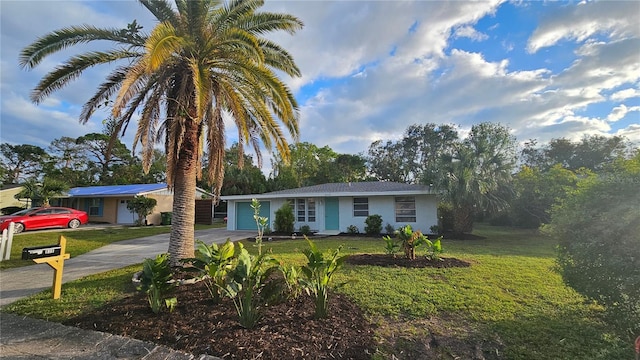 ranch-style house with a front yard and a garage