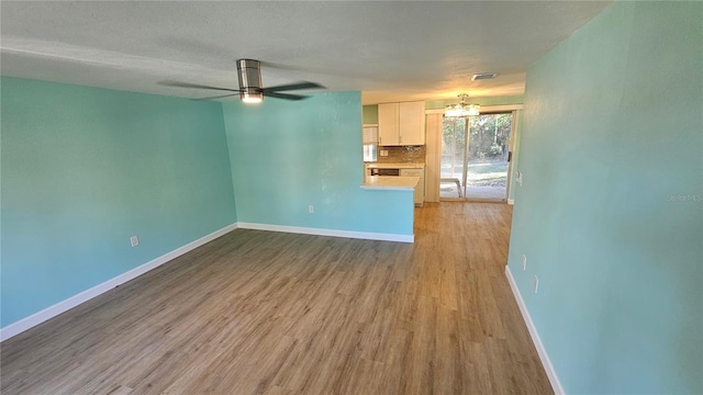 unfurnished living room with ceiling fan, light hardwood / wood-style flooring, and a textured ceiling