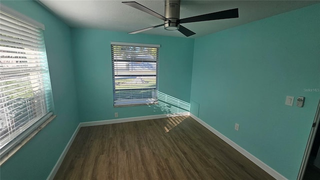 unfurnished room with ceiling fan and dark wood-type flooring