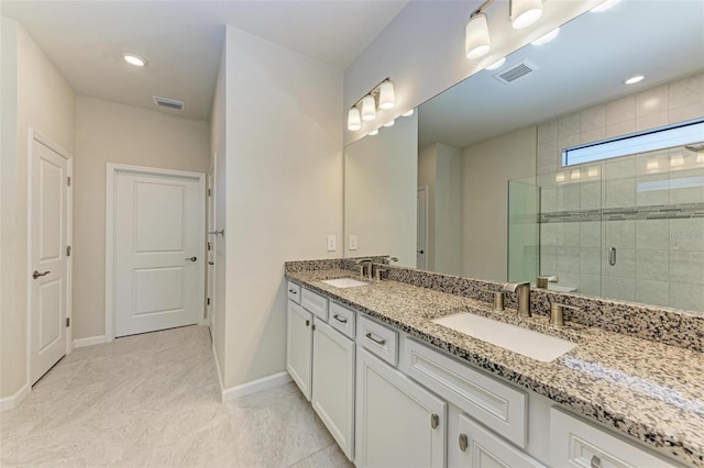 bathroom with tile patterned floors, vanity, and walk in shower