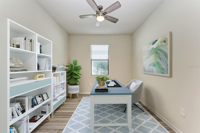 home office with wood-type flooring and ceiling fan