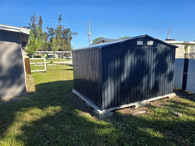 view of outbuilding with a lawn