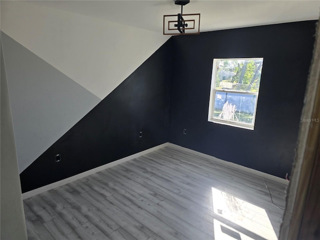 unfurnished dining area featuring light wood-type flooring and a chandelier