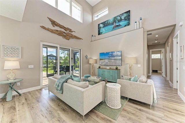 living room featuring hardwood / wood-style floors and a towering ceiling