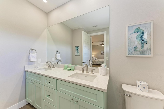 bathroom with vanity, toilet, and ceiling fan