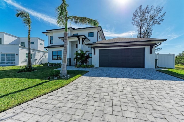 view of front of property with a garage and a front lawn