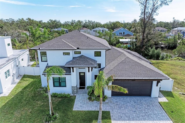 901 30th Ct E, Bradenton, FL 34208 - view of front of property with stucco siding, an attached garage, roof with shingles, decorative driveway, and a residential view