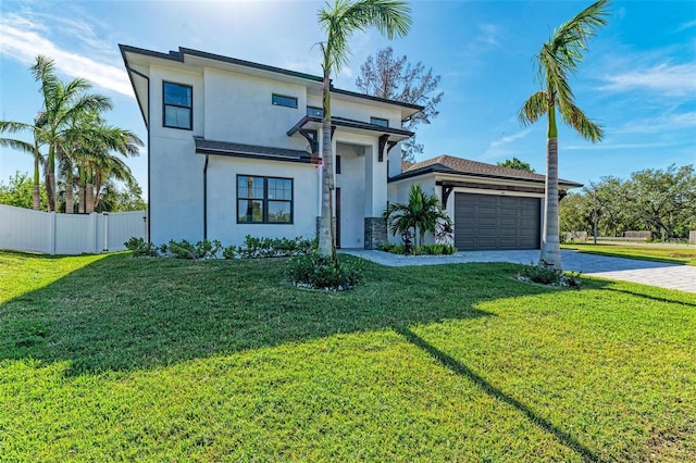 view of front of property featuring a garage and a front lawn