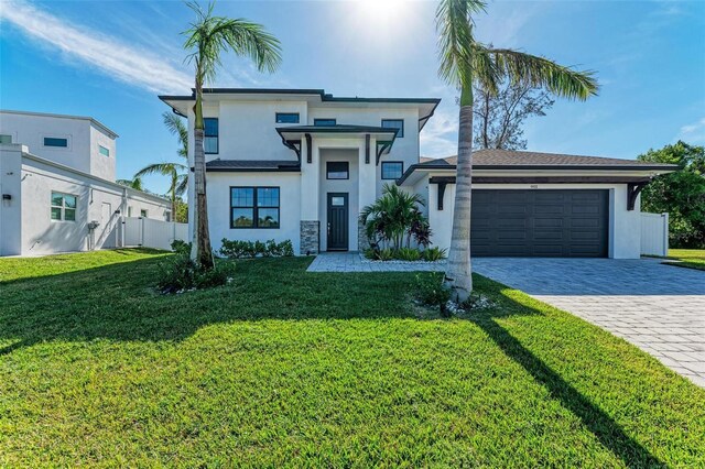 901 30th Ct E, Bradenton, FL 34208 - view of front facade featuring an attached garage, decorative driveway, and stucco siding