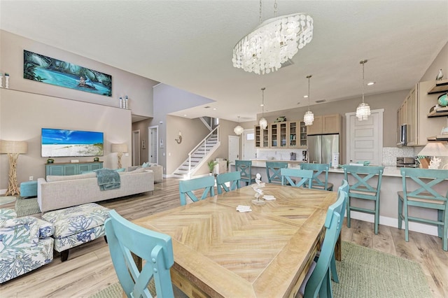 dining area with a chandelier and light wood-type flooring