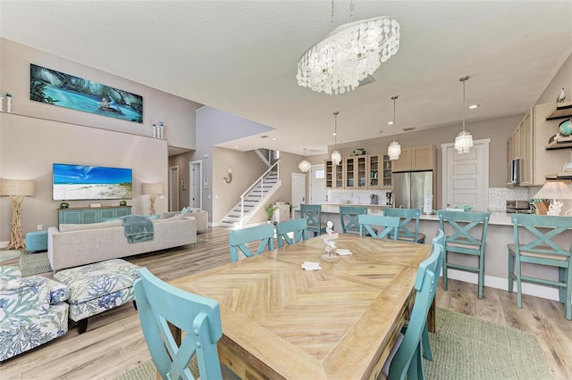 901 30th Ct E, Bradenton, FL 34208 - dining space with a chandelier, stairway, light wood-type flooring, and recessed lighting