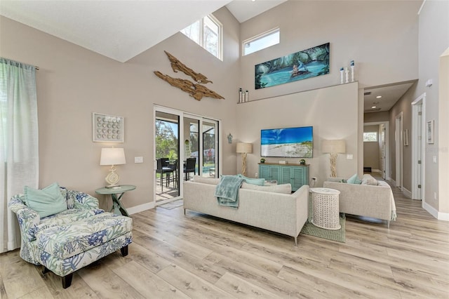 901 30th Ct E, Bradenton, FL 34208 - living room with light wood-style flooring, a high ceiling, and french doors