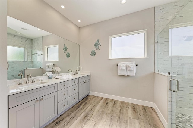 bathroom featuring vanity, hardwood / wood-style flooring, and walk in shower