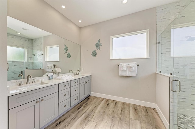 901 30th Ct E, Bradenton, FL 34208 - full bathroom with double vanity, a stall shower, wood finished floors, and recessed lighting