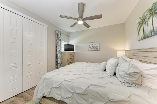 bedroom featuring ceiling fan, a closet, and light hardwood / wood-style flooring