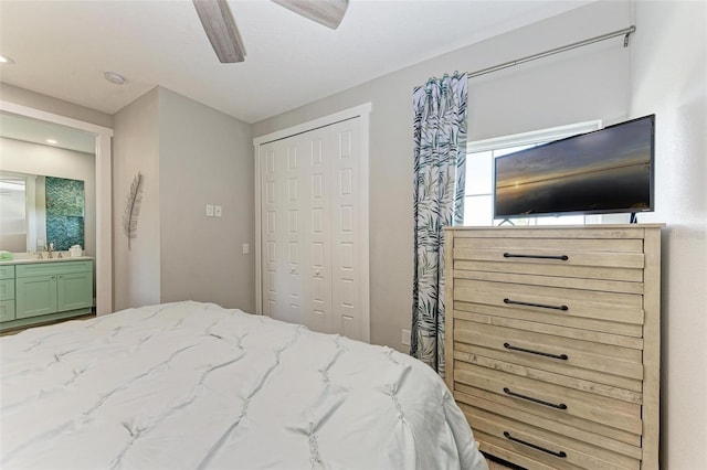 bedroom featuring ensuite bathroom, a closet, ceiling fan, and sink