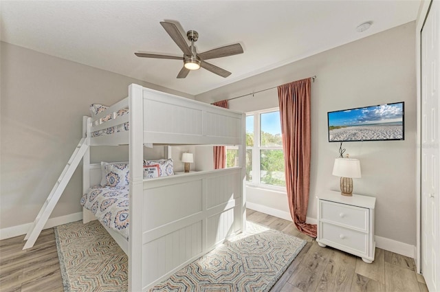 bedroom with ceiling fan and light wood-type flooring