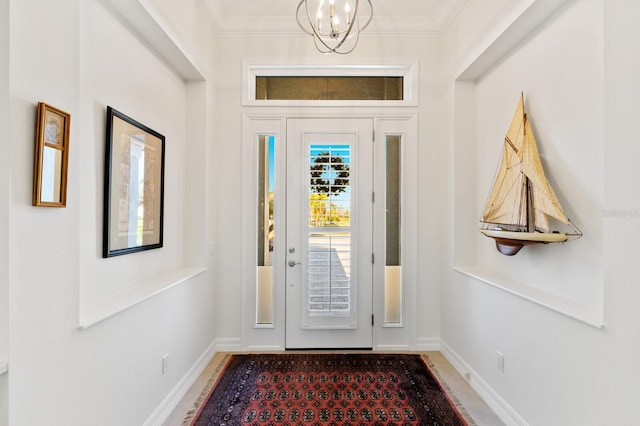 foyer featuring an inviting chandelier and ornamental molding