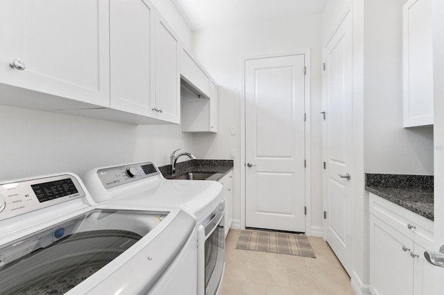 clothes washing area with cabinets, separate washer and dryer, sink, and light tile patterned floors