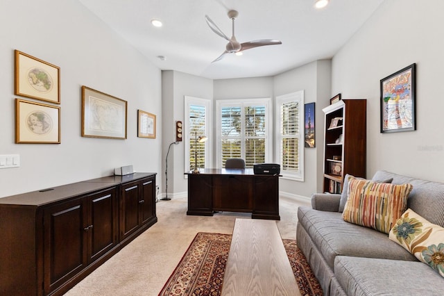 carpeted office space with ceiling fan