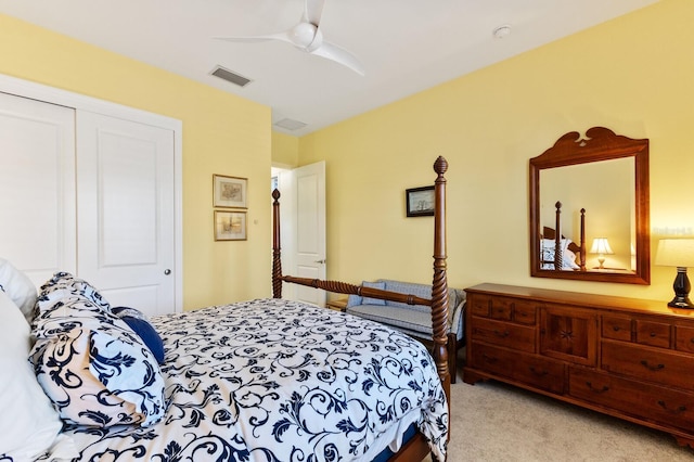 bedroom featuring ceiling fan, a closet, and light carpet