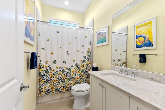 bathroom with tile patterned flooring, vanity, and toilet