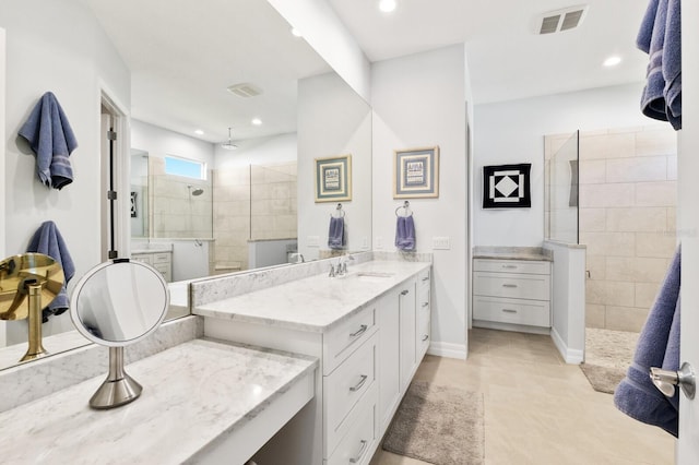 bathroom featuring vanity and tiled shower