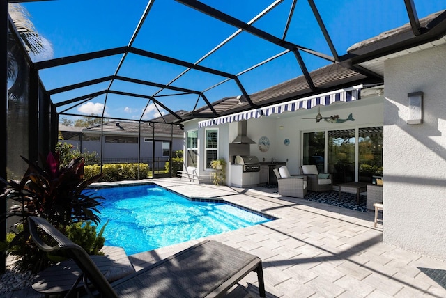 view of swimming pool with ceiling fan, exterior kitchen, a lanai, grilling area, and a patio