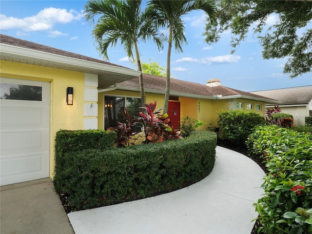 doorway to property with a garage