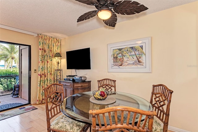 dining area featuring ceiling fan, light hardwood / wood-style floors, and a textured ceiling