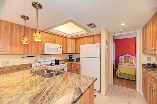 kitchen featuring sink, hanging light fixtures, light stone counters, white appliances, and light tile patterned flooring