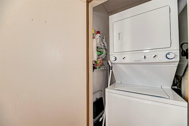 laundry area featuring stacked washer / dryer