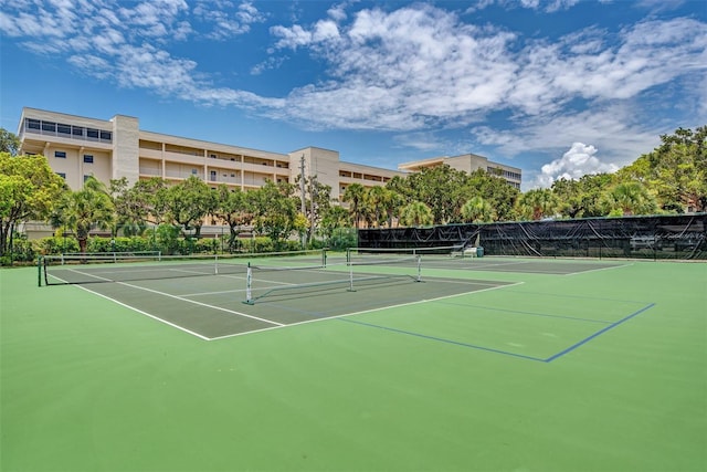 view of tennis court featuring basketball hoop