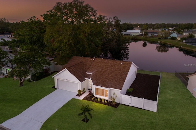 aerial view at dusk with a water view