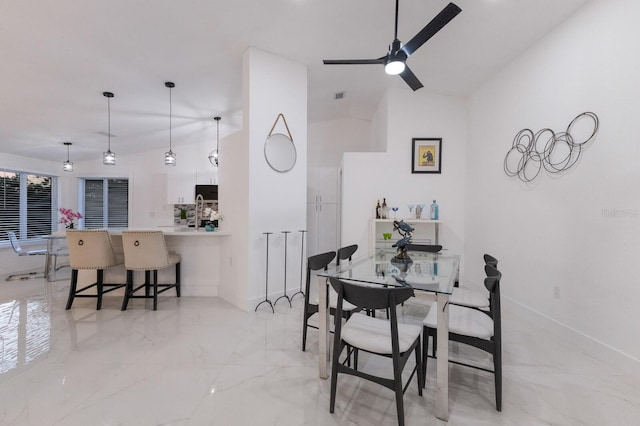 dining area featuring ceiling fan and lofted ceiling