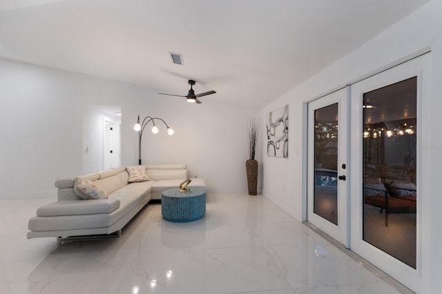 living room featuring ceiling fan, french doors, and vaulted ceiling