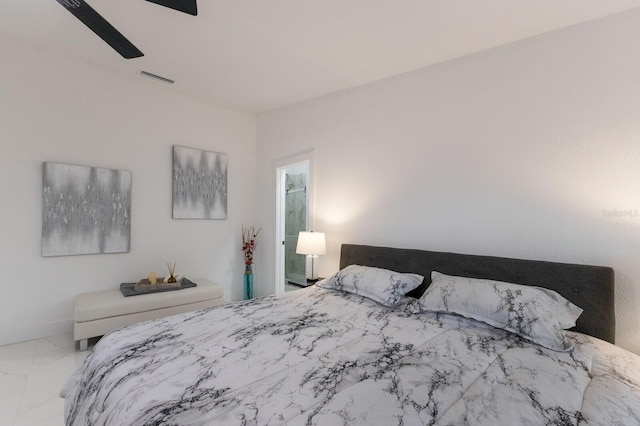 bedroom with ensuite bath and ceiling fan