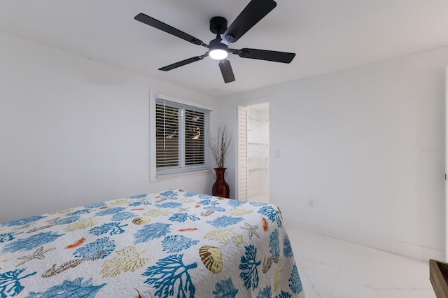 bedroom with ceiling fan, a closet, and a spacious closet