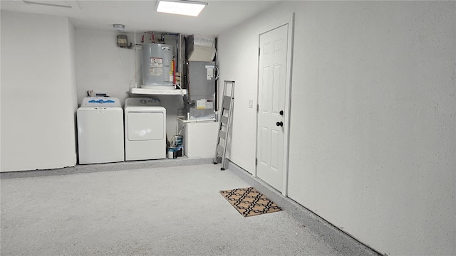 interior space with washer and dryer, electric water heater, and heating unit