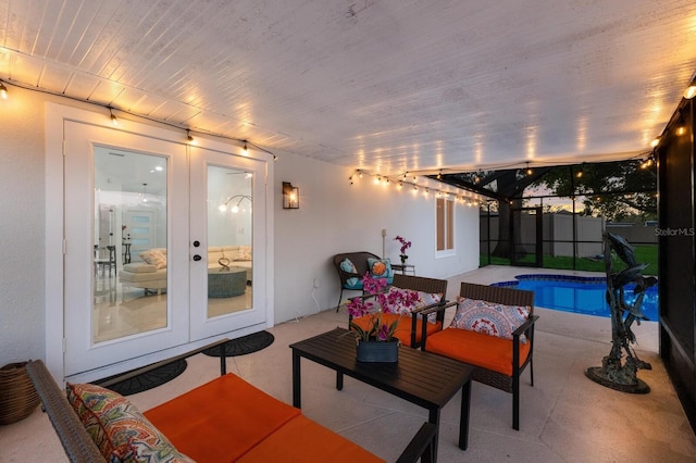 view of patio / terrace featuring a fenced in pool, glass enclosure, an outdoor living space, and french doors