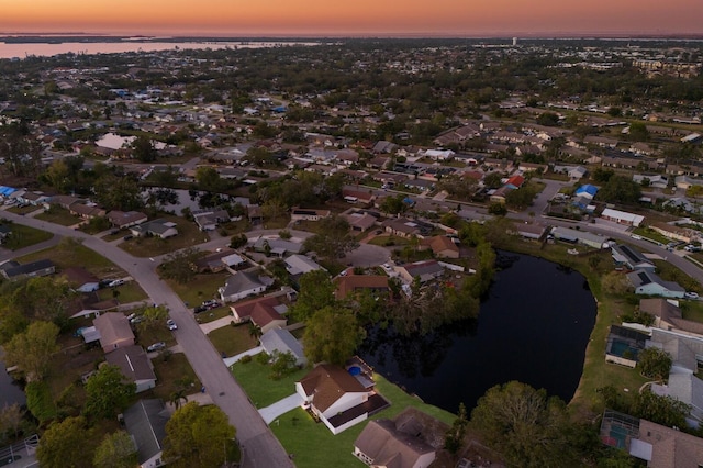 aerial view at dusk with a water view